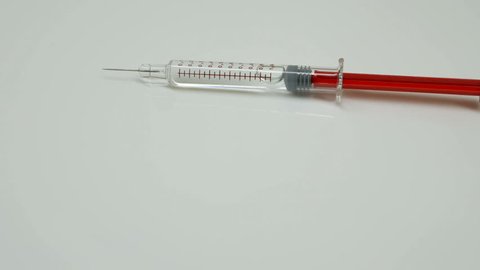 rotation of one new unused syringes, white backgrpund