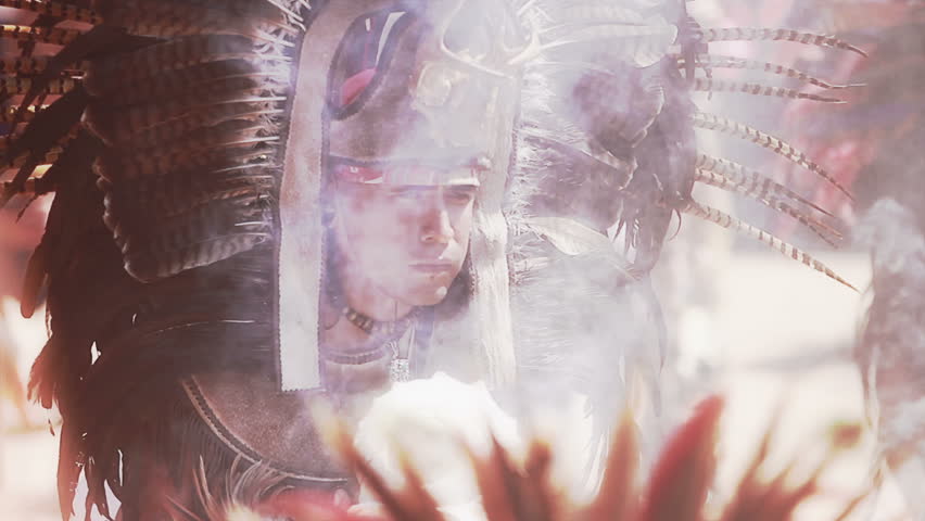 MEXICO, IXCATEOPAN - CIRCA FEBRUARY 2012: Mexican man makes an offering to their Aztec god and dances around fire and smoke