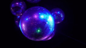 Disco ball spinning colorful light ray in nightclub retro bar