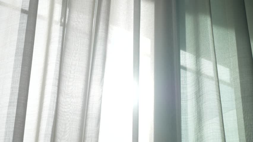 A transparent curtain on the window, gently moved by the wind. sunlight. 4k | Shutterstock HD Video #33706624