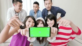 young people show screen to you and smile happily, focus on the phone