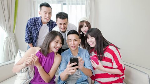 young people use phone and smile happily