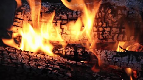 Seamless loop features burning logs in a campfire with dancing flames and glowing embers. Filmed at 1920x1080p HD widescreen.
