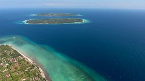 Aerial video of natural landscape of tropical isles for recreation located in ocean, bird's eye view of marine infinite with turquoise sea water surface and tranquil scenery during hot summer weather 