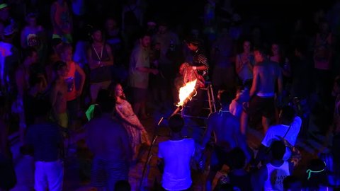 KOH PHANGAN, THAILAND - NOVEMBER 16, 2016 : Girls and guys participate in Full Moon party in island Koh Phangan, Thailand. Event now attracts anywhere from 40,000 party-goers on a normal month