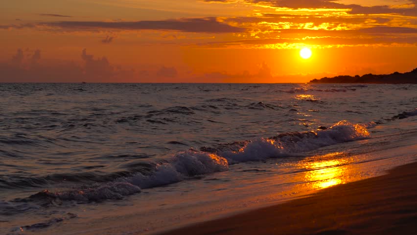 Beautiful sunset at the beach, amazing colors, light beam shining through the cloudscape over the ionian sea, Greece. Time-lapse