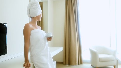 girl in a hotel room drinking coffee