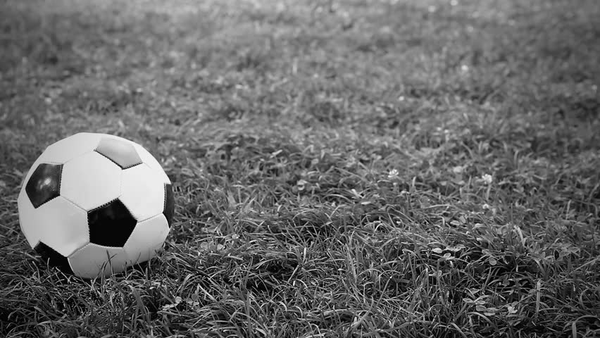 Soccer ball on the grass of football field