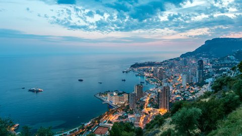 Aerial top view of Monaco from the grand corniche road day to night transition timelapse, Monaco France. Evening illumination. Reflections in water of harbor