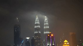 Kuala Lumpur, Malaysia - November 25, 2017: 4k b-roll cinematic footage of night scene at Kuala Lumpur city skyline overlooking the famous Petronas Twin Towers KLCC and KL Tower, aerial view. 