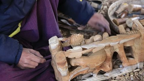 MANDALAY, MYANMAR - JANUARY 17, 2016 : Burmese man are making wooden souvenirs for tourists. Wood Carving is a traditional handicraft in Myanmar