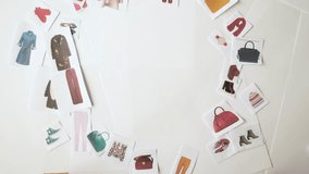 The stylist selects a wardrobe using the example of paper decorations