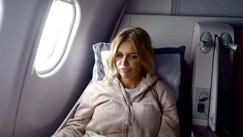 Beautiful blonde woman on a flight.