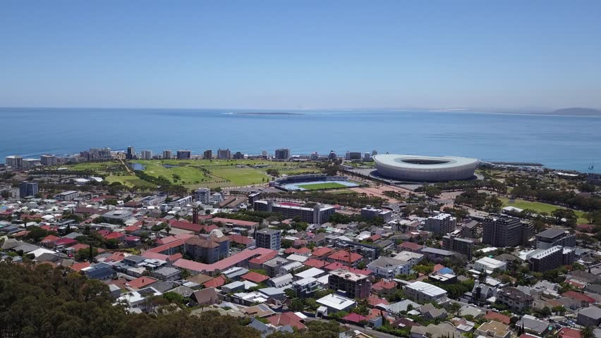 4K high quality aerial video scenic view of Signal Hill, Cape Town city center bowl, view of Table Bay, football stadium and Table Mountain in the background in Cape Town, South Africa on sunny day