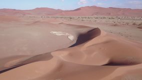 4K high quality aerial video scenic drone view of famous endless sand sea and Sossusvlei Namib Desert red sand dunes on sunny morning in Namib-Naulkuft Park in Namibia, southern Africa