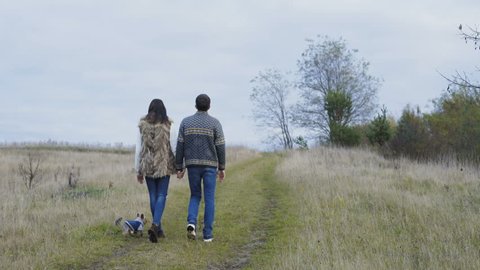 Lovely young couple walking on nature and caressing. 4K.