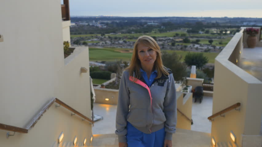 Beautiful lady at the staircase of luxury house