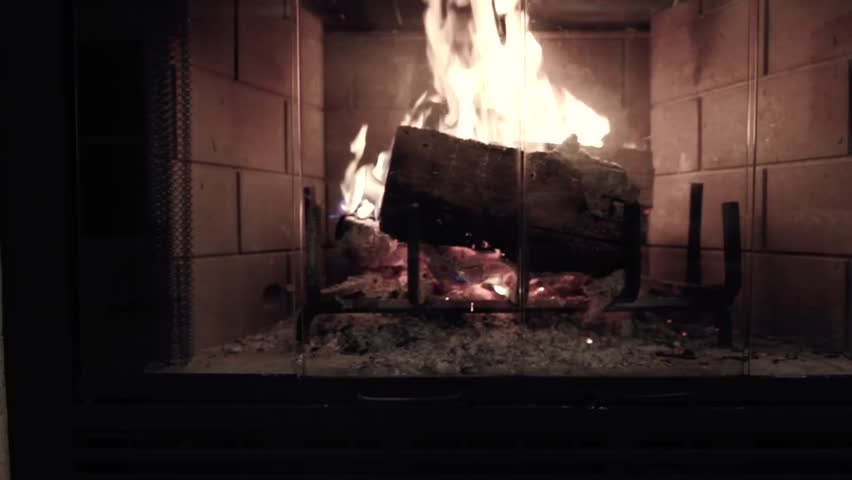 A jib shot of a roaring fire in a country home