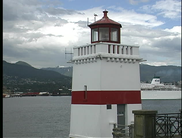 Cruise ship sails past Brockton Point lighthouse in Vancouver, BC