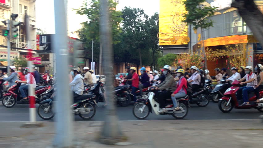 HO CHI MINH CITY - FEBRUARY 1: Panning view of scooter traffic in Ho Chi Minh