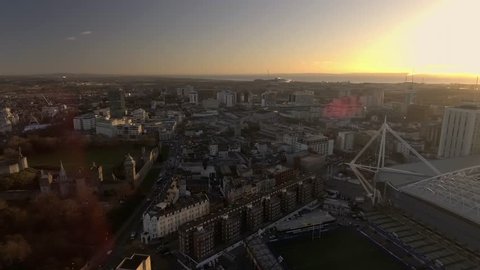 CARDIFF, WALES - 2017: Panning aerial view of Cardiff city centre and the Millennium stadium at sunrise.
