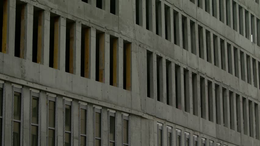 A crane lets down a concrete bar at a shell with many windows at the future "Austria Campus" in the Nordbahnviertel in Vienna.