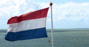 Holland flag with strong wind on sea