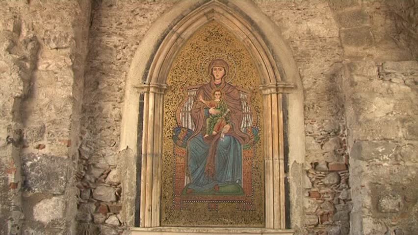 byzantine style golden mosaic with religious figures in the town gate. Italy,Sicily,Taormina