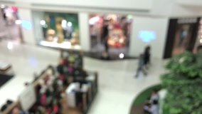 Video blurry people walking and sitting in shopping center, relaxing lifestyle on holiday concept