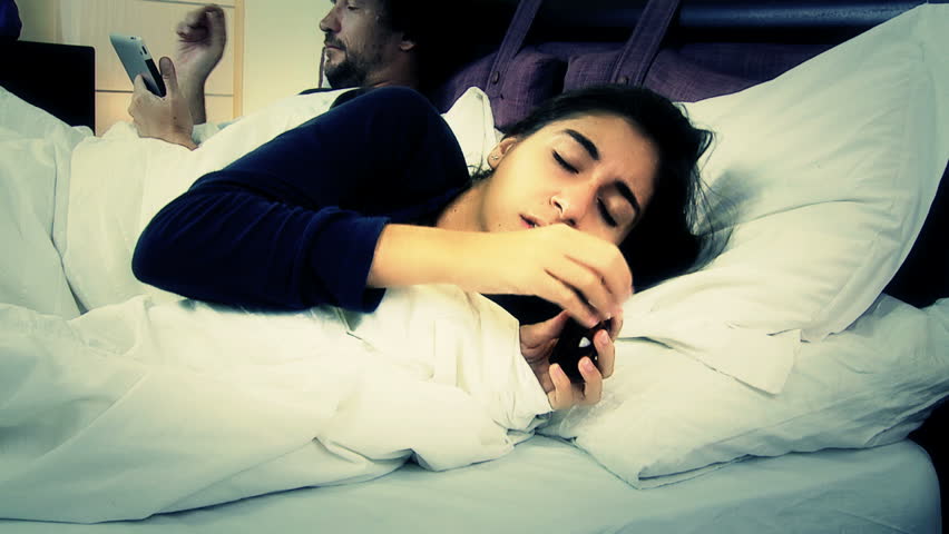 Woman with flu in bed taking medicine ignored by husband