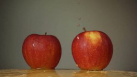 The apple falls on the table in slow motion
