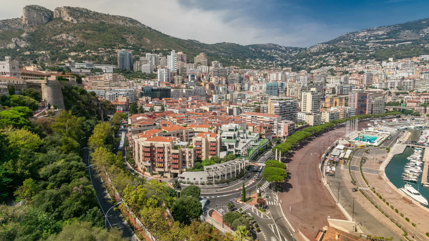 Panorama of Monte Carlo timelapse from the observation deck in the village of Monaco near Port Hercules. Roofs of houses and buildings and hills on background aerial top view