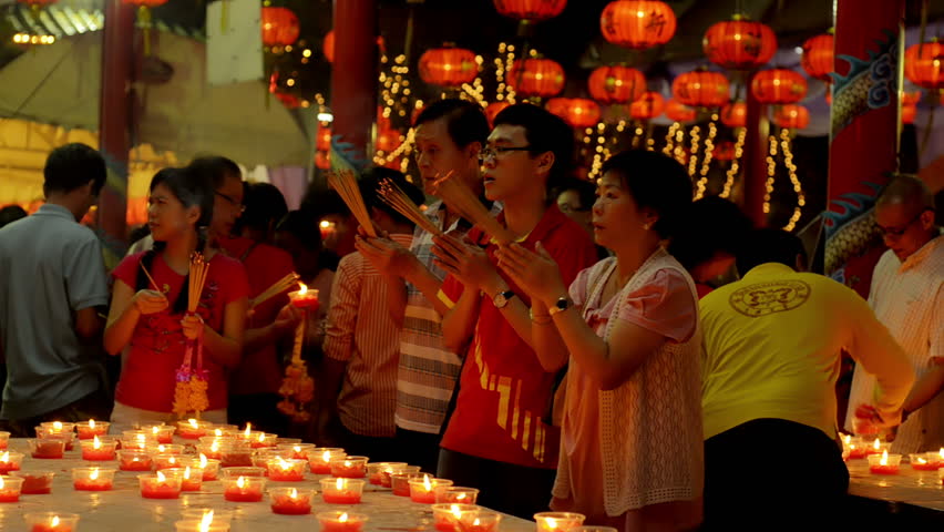 BANGKOK, THAILAND  - FEBRUARY 9, 2013: Thai-Chinese family praying for a