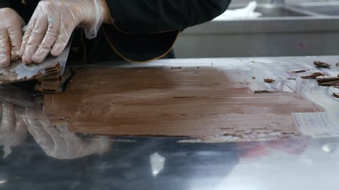 A confectioner making chocolate decorations...