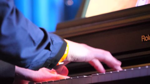 Man hands playing piano, close up. Hands Playing Old Piano. Close up of a musician playing a piano keyboard