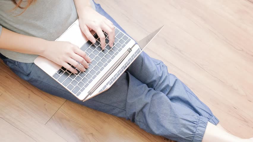 woman use notebook and sit on floor in home