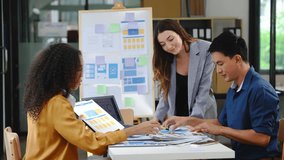 diverse team of professionals engaged in a website graphic design board meeting, sharing opinions on UX and UI design elements. Asian man, African American people, black, afro, caucasian female - Powered by Shutterstock - Get 15% off with code: PIKWIZARD15