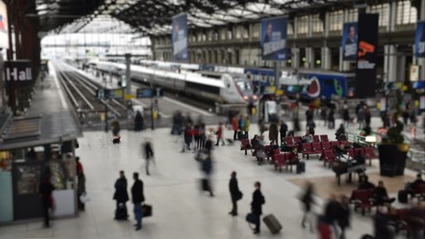 Paris, France - November 23, 2017: UltraHD 4k Tilt Shift: People walking and trains moving in Paris Gare de Lyon (Lyon Train Station), France