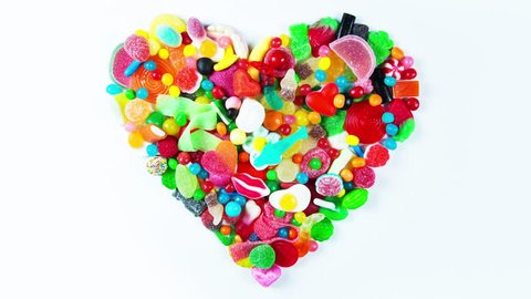 a large collection of sweets and candy made into a heart shape