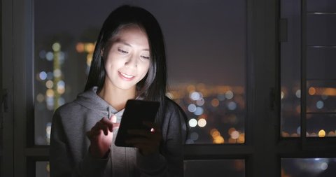 Asian woman use of smart phone at home in the evening
