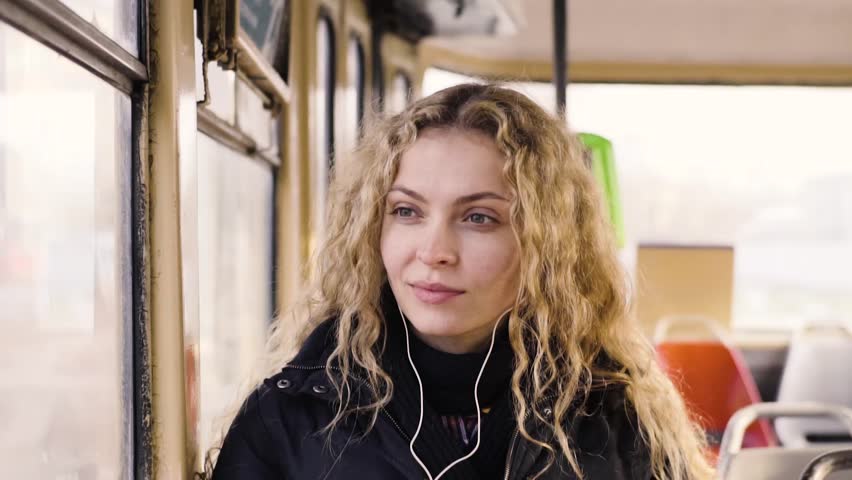 Pretty woman listening music in headphones on smartphone riding tram | Shutterstock HD Video #33787057