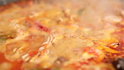 Delicious Paella typical spanish food boiling zoom