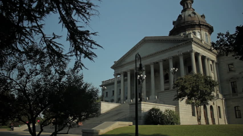 The South Carolina capitol building in Columbia. Daytime wide shot exterior with left to right pan.