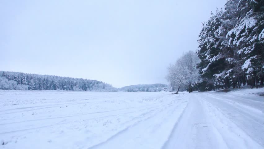 santa claus with a bag and gifts goes on snow