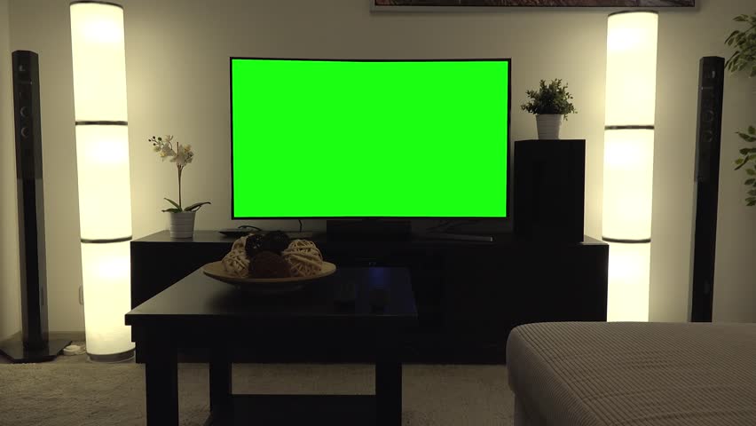 A Tv With A Green Screen In A Cozy Living Room