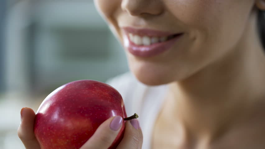 Hungry girl with great appetite biting big juicy apple, healthy snack at work Royalty-Free Stock Footage #33804310