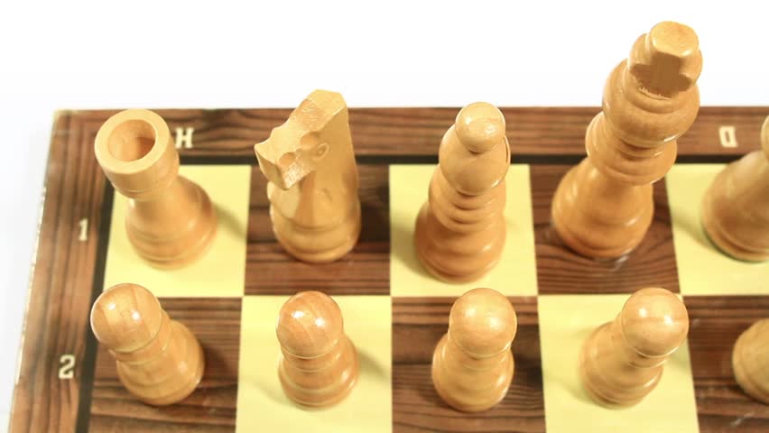 Chess pieces lined up on the first rank. Camera pan from left to right. 
