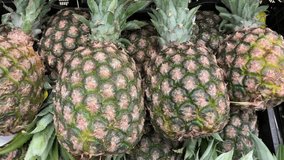 video of a group of pineapples in a local market. Fruit and food concept.