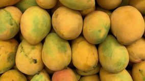 video of a group of mangoes in a local market. Fruit and food concept.