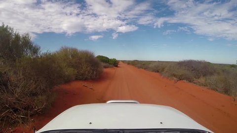 POV driving on rough outback gravel red sand track in Francois Peron NP near Shark Bay in Western Australia